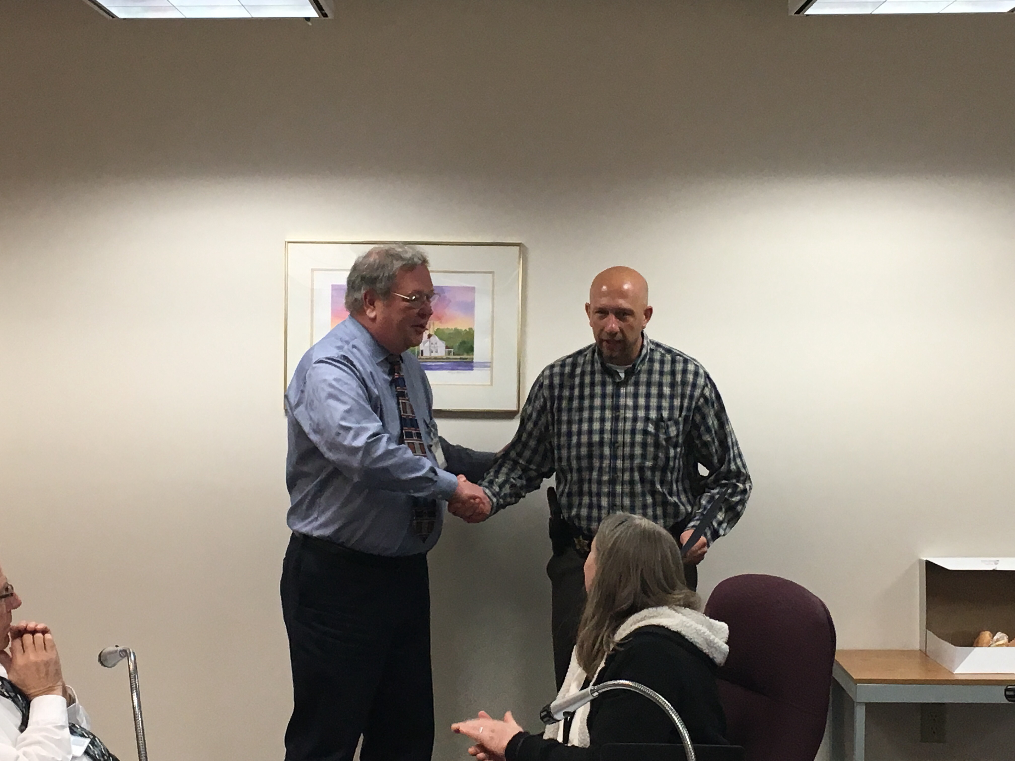 Det. Schneider receives a plaque for his 20 yeras of service from Oceana County Board of Commissioners Chairman Denny Powers.